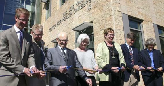 FROM LEFT TO RIGHT: U.S. Congressman Derek Kilmer, Forma Construction Senior Project Manager Mike Rogers, H.C. "Joe" Harned, NBBJ Architects Principal Liz Jacks, Tacoma Community College President Dr. Pamela Transue, Senior Health Policy Advisor to Governor Jay Inslee Dr. Bob Crittenden, and U.S. Representative Laurie Jinkins cut a ceremonial ribbon Thursday to celebrate the grand opening of the H.C. "Joe" Harned Center for Health Careers. (PHOTO BY TODD MATTHEWS)