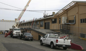 Work is under way to replace the roof on the 104-year-old former Tacoma Municipal Barn in downtown Tacoma. The building was recently added to Tacoma's Register of Historic Places. (PHOTO BY TODD MATTHEWS)