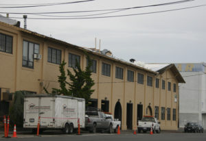 Work is under way to replace the roof on the 104-year-old former Tacoma Municipal Barn in downtown Tacoma. The building was recently added to Tacoma's Register of Historic Places. (PHOTO BY TODD MATTHEWS)