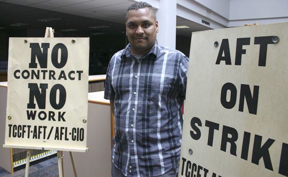 Coleman displays the picket signs used by former TCC history professor Murray Morgan during a faculty strike in the 1970s. (PHOTO BY TODD MATTHEWS)