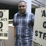 Coleman displays the picket signs used by former Tacoma Community College history professor Murray Morgan during a faculty strike in the 1970s. (FILE PHOTO BY TODD MATTHEWS)