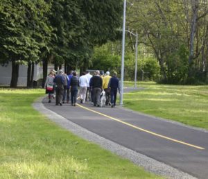 Pedestrians gathered near South 74th Street and South Cedar Street for a ribbon-cutting ceremony to mark the recently restored 1.8-mile segment of the historic Water Flume Line Trail. (PHOTO BY TODD MATTHEWS)