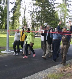 Pedestrians gathered near South 74th Street and South Cedar Street for a ribbon-cutting ceremony to mark the recently restored a 1.8-mile segment of the historic Water Flume Line Trail. (PHOTO BY TODD MATTHEWS)