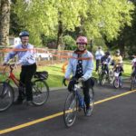 Tacoma City Councilmember Lauren Walker led a group of cyclists along a recently completed section of the historic Water Flume Trail during a ribbon-cutting ceremony Wednesday in Tacoma. The event marked the completion of the second phase of what will eventually be a 6.5-mile trail linking South Tacoma to downtown Tacoma. (PHOTO BY TODD MATTHEWS)