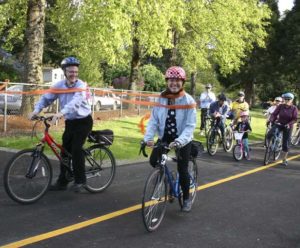 Tacoma City Councilmember Lauren Walker led a group of cyclists along a recently completed section of the historic Water Flume Trail during a ribbon-cutting ceremony Wednesday in Tacoma. The event marked the completion of the second phase of what will eventually be a 6.5-mile trail linking South Tacoma to downtown Tacoma. (PHOTO BY TODD MATTHEWS)