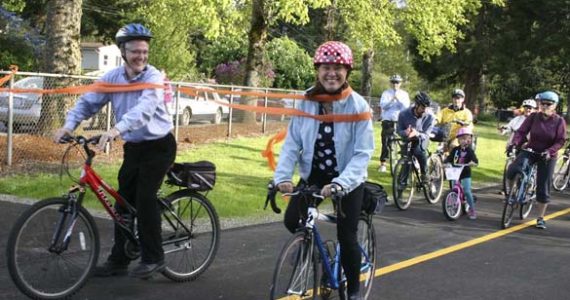 Tacoma City Councilmember Lauren Walker led a group of cyclists along a recently completed section of the historic Water Flume Trail during a ribbon-cutting ceremony Wednesday in Tacoma. The event marked the completion of the second phase of what will eventually be a 6.5-mile trail linking South Tacoma to downtown Tacoma. (PHOTO BY TODD MATTHEWS)