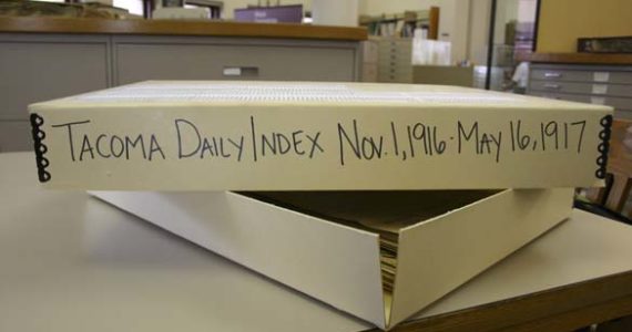 A box stored in the archives at Tacoma Public Library's Northwest Room contains issues of the Tacoma Daily Index that date back to 1916. (PHOTO BY TODD MATTHEWS)