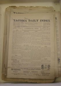 A box stored in the archives at Tacoma Public Library's Northwest Room contains issues of the Tacoma Daily Index that date back to 1916. (PHOTO BY TODD MATTHEWS)