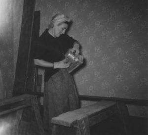 Former Mead House property owner Paula Keyser doing home improvement work in 1956. Paula and her husband, Bill, owned the home for more than 40 years and filled it with material salvaged from some of Tacoma's most historically significant buildings before the structures were demolished. (PHOTO COURTESY SUSAN JOHNSON / ARTIFACTS CONSULTING)