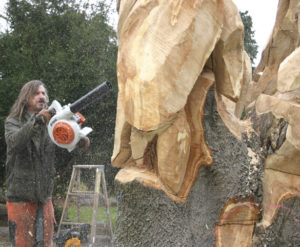 Local painter, illustrator, and chainsaw sculptor Bruce 'Thor' Thorsteinson was hired last year to turn a dead maple tree in Tacoma into a work of art. (FILE PHOTO BY TODD MATTHEWS)