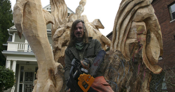 Local painter, illustrator, and chainsaw sculptor Bruce 'Thor' Thorsteinson was hired last year to turn a dead maple tree in Tacoma into a work of art. (FILE PHOTO BY TODD MATTHEWS)