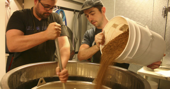 Jesse Dunagan (right) and Jon Russell prepare an Irish stout at Dunagan Brewing Co. in downtown Tacoma. (PHOTO BY TODD MATTHEWS)