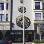 The art installation consists of a trio of three-dimensional metal, laser-cut half-spheres that range in diameter between three feet, five feet, and eight feet, and feature an intricate design pattern. The pieces will be bolted to a blank facade situated between two historic buildings on Broadway. (IMAGE COURTESY JONATHAN CLARREN)