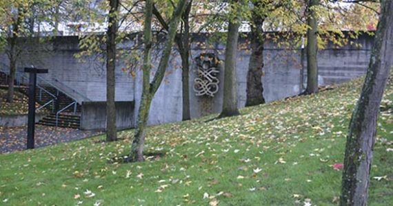 Harold Balazs's "Untitled (Concrete Sculpture)" is seen through the trees at Bicentennial Pavilion in downtown Tacoma. Citing safety concerns, the City of Tacoma plans to remove the 40-year-old sculpture. (PHOTO BY TODD MATTHEWS)