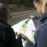 Barbara Reid and Hancock Forest Management Assistant Forester Heather A. Watson consult a map en route to the heart of Vancouver Notch in October. A section of The Divide is in the distance. (PHOTO BY TODD MATTHEWS)