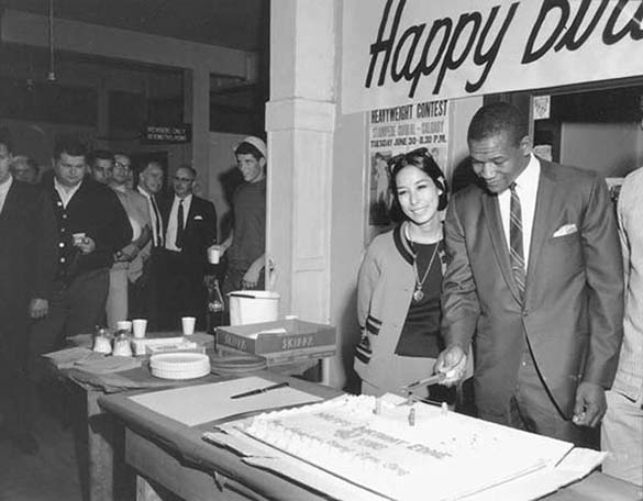 Fans line up for a piece of cake to celebrate local boxer Eddie Cotton on June 15, 1967, in honor of his 41st birthday. (ELMER OGAWA PHOTOGRAPH / COURTESY UNIVERSITY OF WASHINGTON LIBRARIES SPECIAL COLLECTIONS)