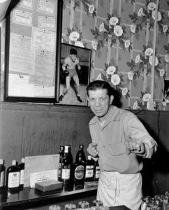 A bartender (and former boxer) at Seattle's Banquet Tavern circa 1952. (ELMER OGAWA PHOTOGRAPH / COURTESY UNIVERSITY OF WASHINGTON SPECIAL COLLECTIONS)
