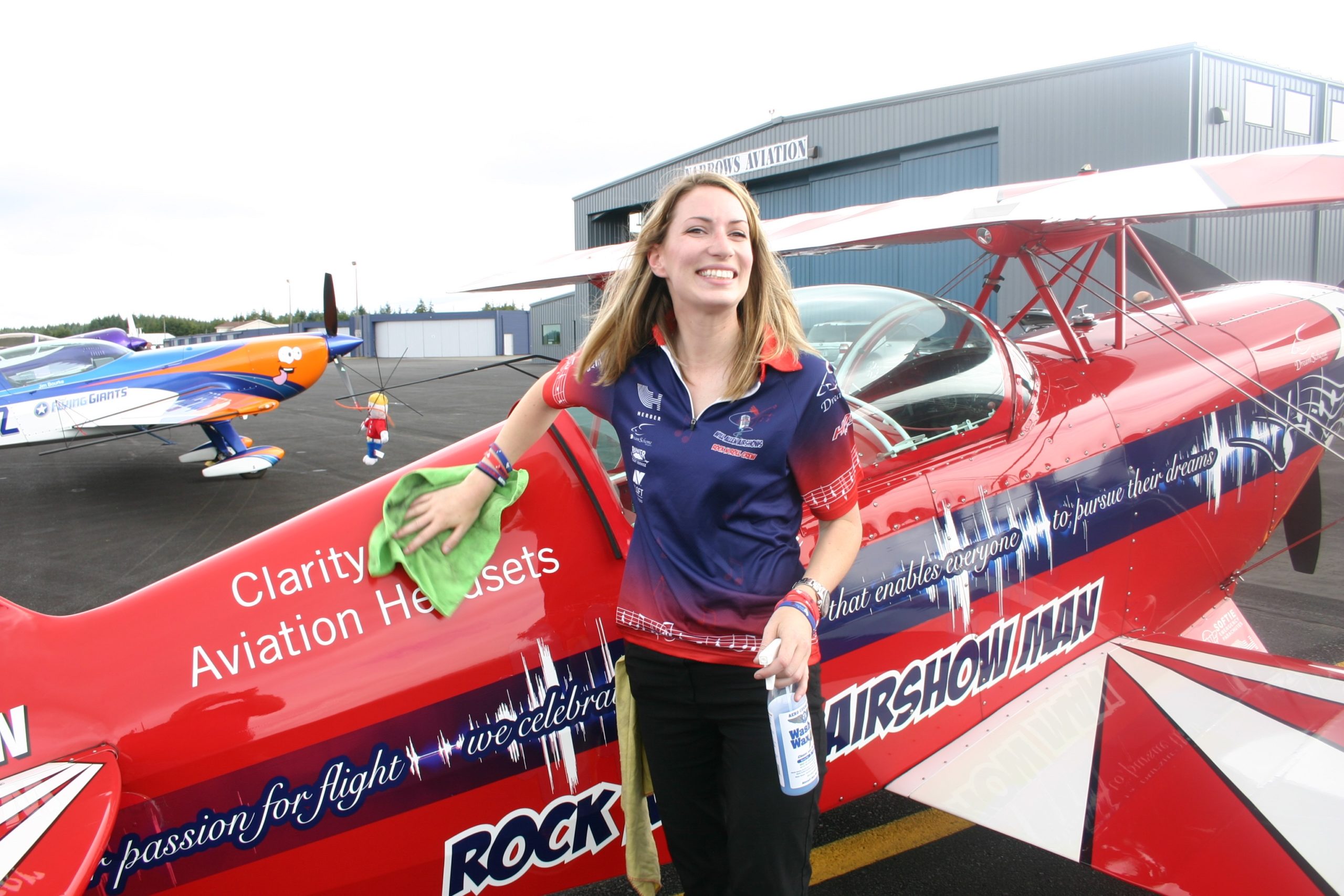 Vancouver, B.C. aerobatics pilot Jodi Rueger lends a helping hand to wipe down Will Allen's Pitt Special, Saturday, July 2 at Tacoma Narrows Airport. Credit: David Guest / TDI