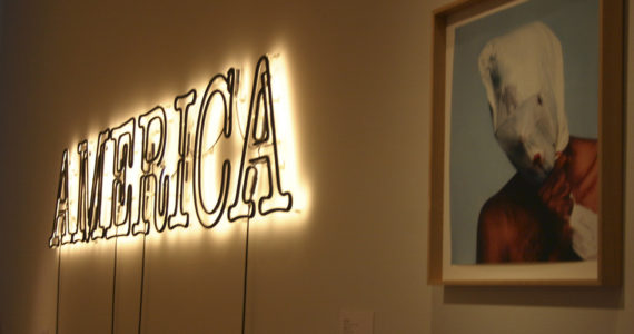 William Pole.L's "Foraging (asphixia version), (2008)" hangs next to Glenn Ligon's neon and paint work "America (2008)" at the Tacoma Art Museum, part of the "30 Americans" traveling exhibition which opened at the museum last week. Credit: David Guest / TDI