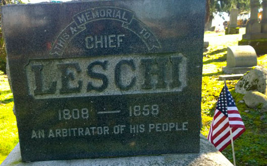 Chief Leschi (of the Nisquallies) was lynched near what is now a strip mall in Lakewood. He is buried in the Puyallup cemetery. Be sure to note the American flag. Native people are noted for dedication to military service. Photo by Morf Morford