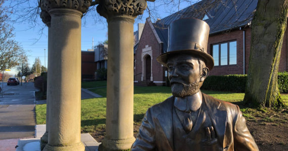 Allen C. Mason statue in the Allen C. Mason Plaza on the corner of North 26th and Adams, adjacent to Tacoma Public Library’s Wheelock Branch. The work of local artist Paul R. Michaels, commissioned by the Proctor District Association and the Tacoma Historical Society. Mr. Mason always leans into the future, sports a jaunty top hat, extends a welcoming hand and is remembered as “Tacoma’s Best Salesman.”  Photo: Morf Morford