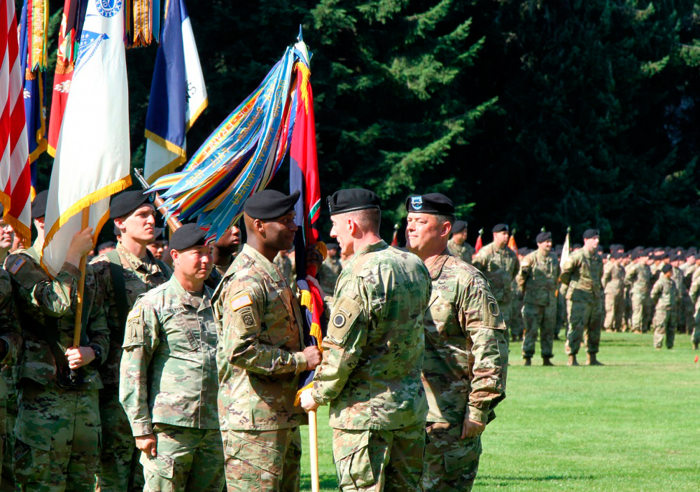 Lt. Gen. Gary Volesky, commanding general, I Corps, passes the 7th Infantry Division colors to Maj. Gen. Xavier T. Brunson, formally recognizing him as the Commanding General of the 7th Infantry Division during a Change of Command ceremony held on Watkins Field on Joint Base Lewis-McChord, Wash., Aug. 13, 2019.Image courtesy DoD/ 7th Infantry Division, Photo credit: Staff Sgt. Michael Armstrong (7th ID)