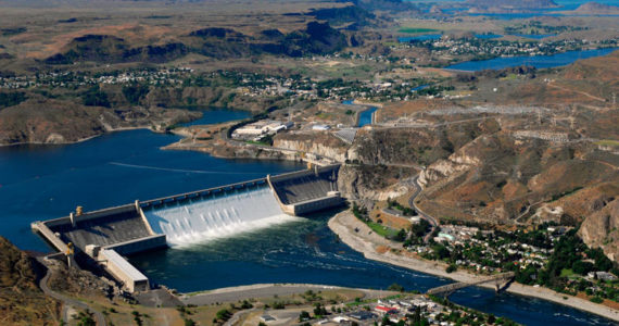 June 30, 2011: Aerial view of Grand Coulee Dam releasing downstream an unusually large and late spring time water flows of over 200,000 cfs. Broken out, it’s 33,800 cfs, over the spillway and 167,000 cfs through the hydropower generators. Image courtesy Bureau of Reclamation