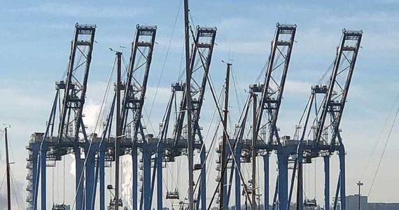 What happens a thousand miles away, or even ten thousand, can have a huge, even multiplier effect on our local economy. These cranes dominate our local economy as much as they do our landscape. (Photo by Morf Morford)