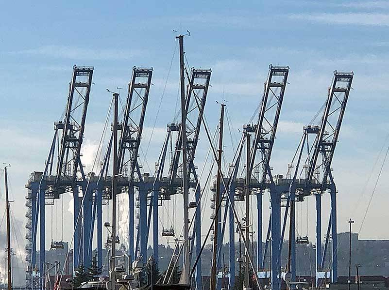 What happens a thousand miles away, or even ten thousand, can have a huge, even multiplier effect on our local economy. These cranes dominate our local economy as much as they do our landscape. (Photo by Morf Morford)
