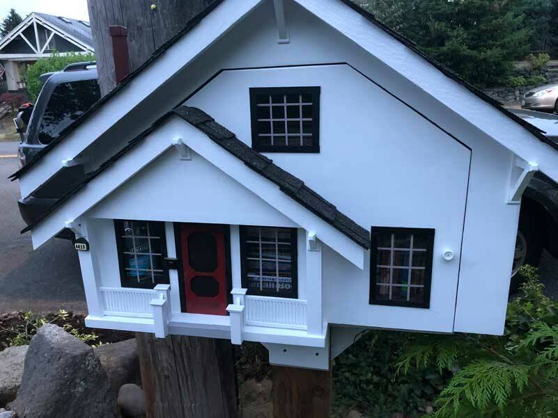 This is actually a Little Free Library in the shape of a ‘traditional’ home. It reflects the assumptions of what a house in this neighborhood should look like. (Photo by Morf Morford)