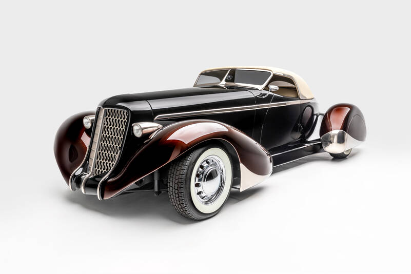 “SLOW BURN”
SPECS: 1936 AUBURN 852 BOATTAIL SPEEDSTER (MODERN REPLICA) BUILDER: RICK DORE KUSTOMS INTERIOR: EGYPTIAN LEATHER BY BOB DEVINE/RICK DORE ENGINE: 350-CUBIC INCH CHEVROLET V-8
<em>Image courtesy LeMay-America’s Car Museum, Petersen Automotive Museum and the Hetfield Family</em>
Bio: “Slow Burn” was crafted from an official Glen Pray recreation of an Auburn Boattail. The fiberglass body made it difficult to alter extensively, so Hetfield and Dore instead added details, like a sloped, Carson-style convertible top, to emphasize the car’s curving lines. The root beer paint color of the fenders, in contrast with the darker body color, highlights their sinuous shape. Accents like the geometric grille, taillight trim, and personally designed wheels exemplify Hetfield’s personal style.