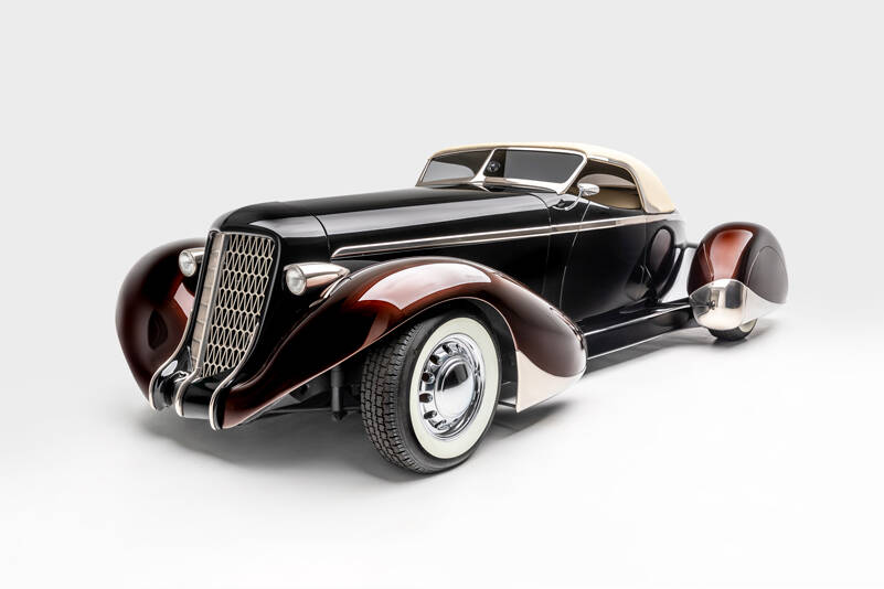 “SLOW BURN”
SPECS: 1936 AUBURN 852 BOATTAIL SPEEDSTER (MODERN REPLICA) BUILDER: RICK DORE KUSTOMS INTERIOR: EGYPTIAN LEATHER BY BOB DEVINE/RICK DORE ENGINE: 350-CUBIC INCH CHEVROLET V-8
<em>Image courtesy LeMay-America’s Car Museum, Petersen Automotive Museum and the Hetfield Family</em>
Bio: “Slow Burn” was crafted from an official Glen Pray recreation of an Auburn Boattail. The fiberglass body made it difficult to alter extensively, so Hetfield and Dore instead added details, like a sloped, Carson-style convertible top, to emphasize the car’s curving lines. The root beer paint color of the fenders, in contrast with the darker body color, highlights their sinuous shape. Accents like the geometric grille, taillight trim, and personally designed wheels exemplify Hetfield’s personal style.