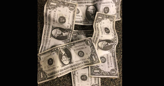 Most of us say that we value money, but I find cash out in public all the time. I recently found this pile of cash on a sidewalk on a rainy day. (Photo by Morf Morford)