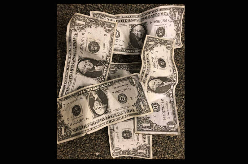 Most of us say that we value money, but I find cash out in public all the time. I recently found this pile of cash on a sidewalk on a rainy day. (Photo by Morf Morford)