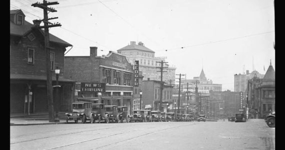 This photograph from May of 1928 shows the buildings on the east side of St. Helens Avenue from 7th Street looking south. Second in from the corner is the building that was shared by the News Tribune and the Tacoma Daily Ledger from 1918 to 1937. Built in 1910 by Darmer & Cutting for the News Tribune, the Ledger moved into the building when it was bought out by the Tribune in 1918. Both papers published independently from this building until the Daily Ledger went out of business in 1937. The News Tribune kept the name of the Ledger alive in the masthead of its Sunday paper until August of 1979, The Tacoma News Tribune and Sunday Ledger. Image and text courtesy Tacoma Public Library, (Chapin Bowen Collection BGN-720)