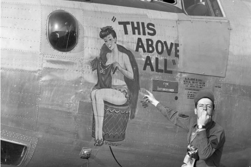 Image: Soldier points at the nose art on a B-24 bomber during World War II. Courtesy The Museum of Flight.