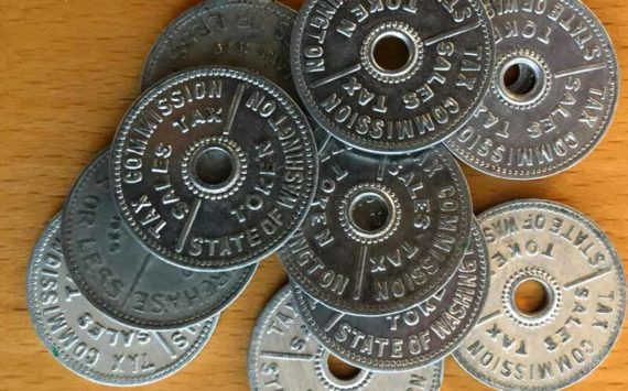 These are Washington state tax tokens. Instead of charging an extra few cents, tax tokens could be purchased and applied to a sale. Several states had these. Washington used them until 1951. (Photo by Morf Morford)