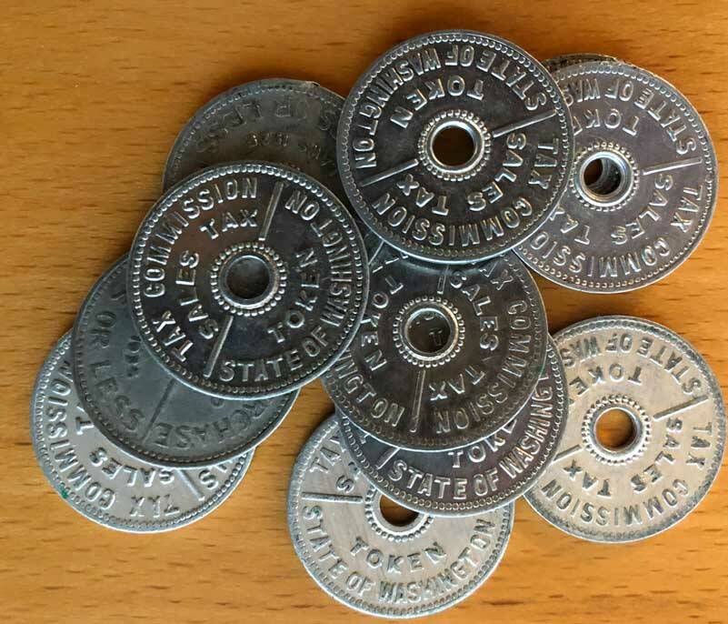These are Washington state tax tokens. Instead of charging an extra few cents, tax tokens could be purchased and applied to a sale. Several states had these. Washington used them until 1951. (Photo by Morf Morford)