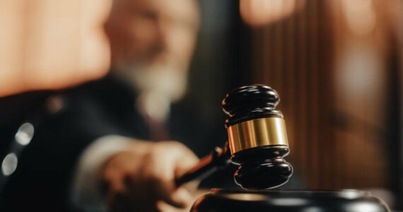 Court of Law and Justice Trial Session: Imparcial Honorable Judge Pronouncing Sentence, striking Gavel. Focus on Mallet, Hammer. Cinematic Shot of Dramatic Not Guilty Verdict. Close-up Shot.