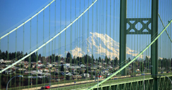 Tacoma Narrows Bridge with Mt Rainier in the background crossing Puget Sound.  There are actually two parrallel suspension bridges, the first opened in 1950 and the second recently completed in 2007.  The 1950 bridge replaced the infamous 'Galloping Gertie' which opened in 1940 and collapsed 4 months later.