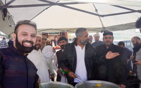 Men serving halal food on Eid Mubarak 2024. Photo By Joshua Solorzano/Sound Publishing