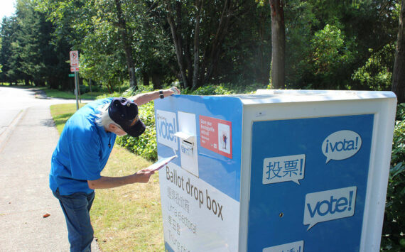 A man places his ballot into the drop box outside Federal Way City Hall. Bailey Jo Josie/Sound Publishing