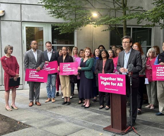Photo by Jake Goldstein-Street/Washington State Standard 
Washington Gov. Bob Ferguson speaks to reporters about federal cuts to Medicaid funding outside a Planned Parenthood clinic alongside advocates, state lawmakers and statewide elected officials on Wednesday, July 9, 2025, in Seattle.