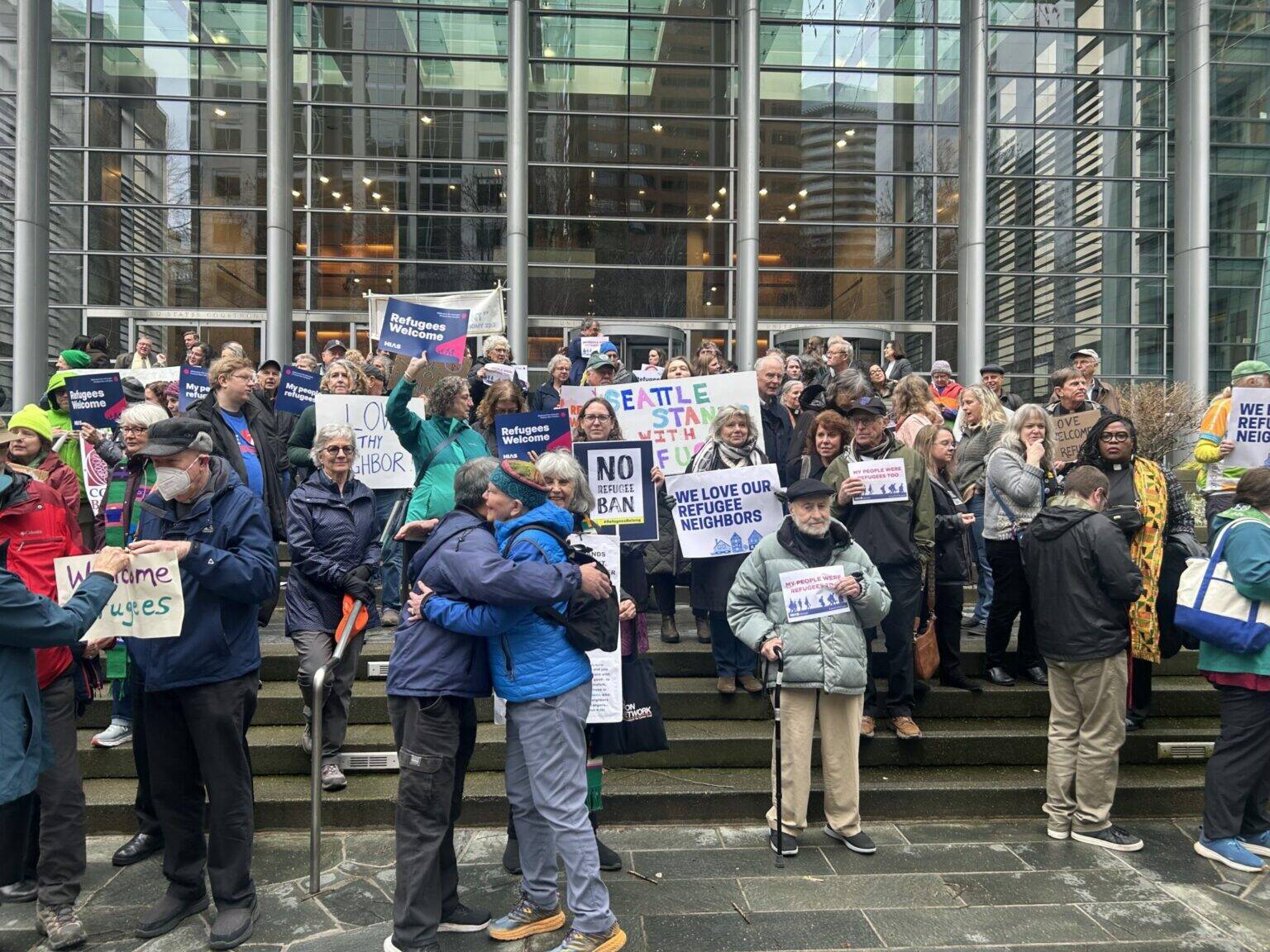 Opponents of President Donald Trump’s executive order indefinitely halting refugee resettlement in the U.S. rally on the steps of the federal courthouse in Seattle on Feb. 25, 2025, after a judge issued a ruling blocking the president’s order. (Photo by Jake Goldstein-Street/Washington State Standard)
