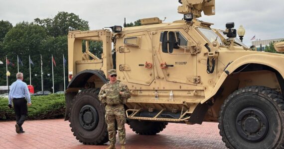 A member of the National Guard stands alongside a military vehicle parked in front of Union Station, near the U.S. Capitol in Washington, D.C., on Aug. 18, 2025. (Photo by Jane Norman/States Newsroom)