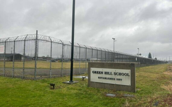 A sign and fence at the Green Hill School for juvenile offenders, in Chehalis, Washington. (Photo by Jake Goldstein-Street/Washington State Standard)