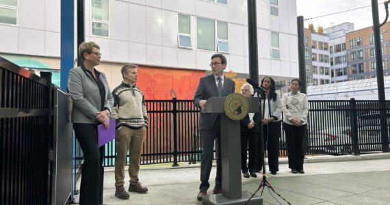 Washington Gov. Bob Ferguson speaks to Andi Smith of the Ballmer Group after the announcement of a major new philanthropic donation to fund early childhood education on Wednesday, Nov. 12, 2025, at the Denise Louie Education Center in Seattle, Washington. (Photo by Jake Goldstein-Street/Washington State Standard)