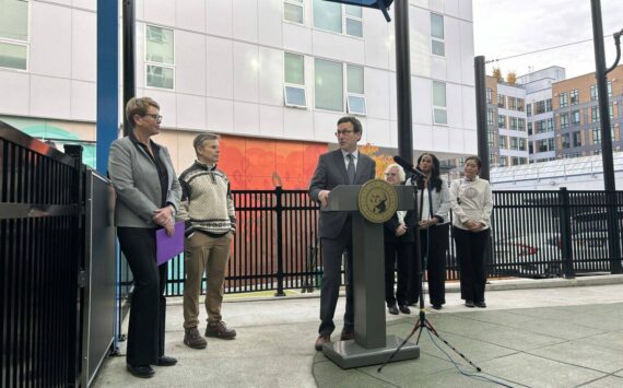 Washington Gov. Bob Ferguson speaks to Andi Smith of the Ballmer Group after the announcement of a major new philanthropic donation to fund early childhood education on Wednesday, Nov. 12, 2025, at the Denise Louie Education Center in Seattle, Washington. (Photo by Jake Goldstein-Street/Washington State Standard)