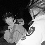 Tacoma City Councilmember Julie Anderson speaks with BIA patrol officer John Leitheiser on a rooftop during an overnight patrol downtown. Officers spend as much time on city streets, where they are visible, as they do on rooftops surveying the area. (PHOTO BY TODD MATTHEWS)
