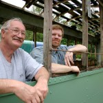 Tom and Vince Mendenhall, father-and-son owners of Arlington, Wash.-based Historic Railway Restoration, inside a  Turtleback streetcar that once operated on Tacoma streets. (PHOTO BY TODD MATTHEWS)